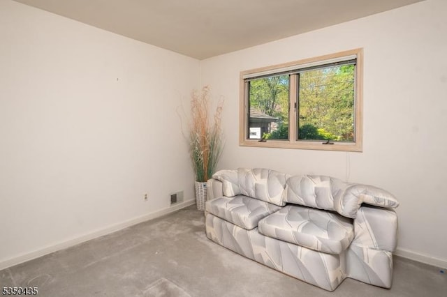 living area featuring baseboards, carpet, and visible vents