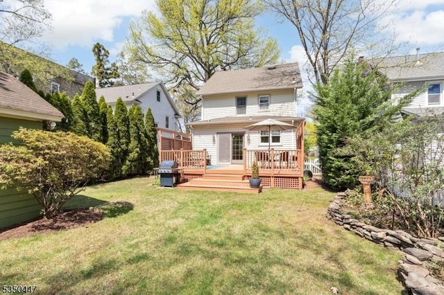back of house featuring a yard and a deck