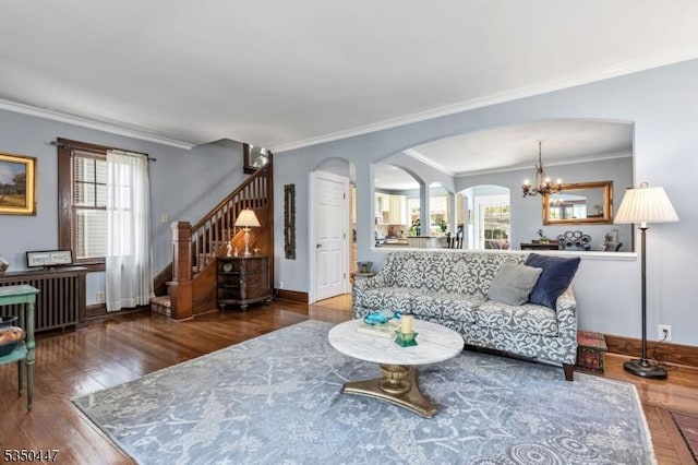living room featuring arched walkways, ornamental molding, and a wealth of natural light