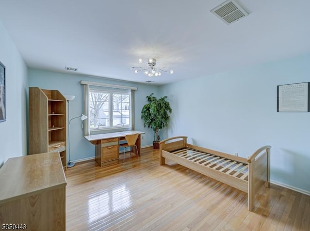 bedroom with baseboards, light wood-style floors, and visible vents