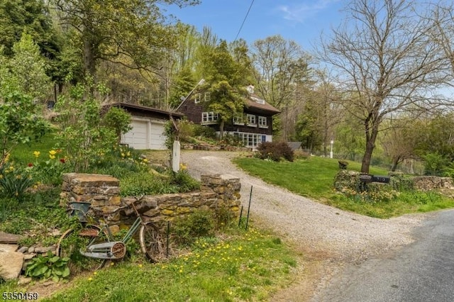 exterior space with driveway and a front lawn