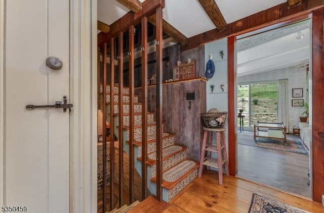 interior space featuring vaulted ceiling with beams and wood finished floors