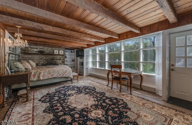 bedroom with wood ceiling, a notable chandelier, multiple windows, and beamed ceiling