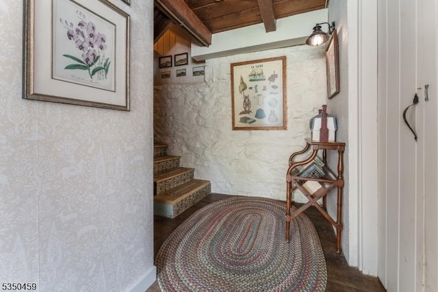 stairway with vaulted ceiling with beams
