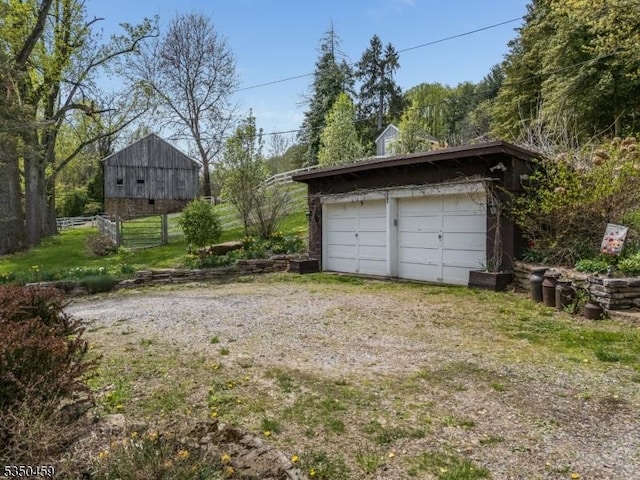 detached garage featuring fence