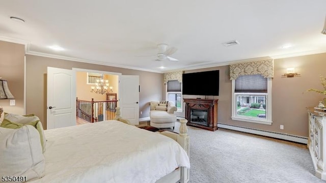 carpeted bedroom with ceiling fan with notable chandelier, a baseboard heating unit, a glass covered fireplace, baseboards, and ornamental molding