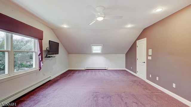 bonus room with a baseboard heating unit, lofted ceiling, and carpet floors