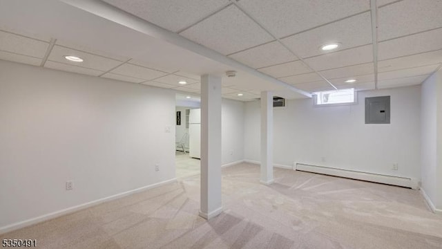 below grade area featuring a baseboard heating unit, electric panel, freestanding refrigerator, recessed lighting, and carpet floors