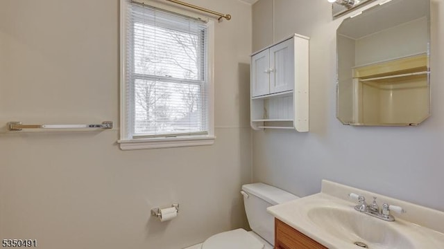 bathroom with a wealth of natural light, toilet, and vanity