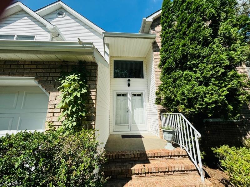 doorway to property with brick siding and a garage