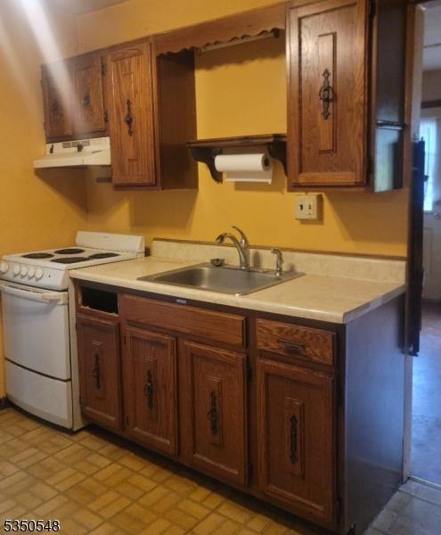 50 Coolidge Trl, Hopatcong Boro, NJ 07843 - kitchen with white electric stove, brown cabinets, a sink, light countertops, and under cabinet range hood