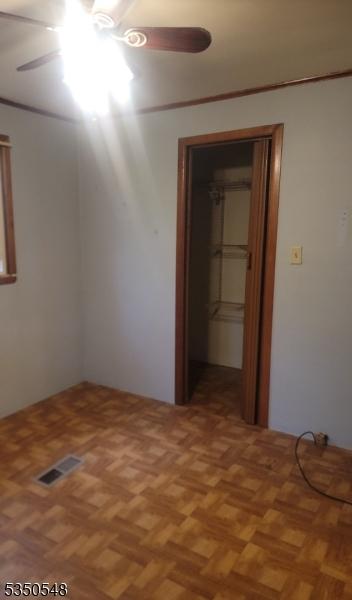 50 Coolidge Trl, Hopatcong Boro, NJ 07843 - unfurnished bedroom featuring a ceiling fan and visible vents