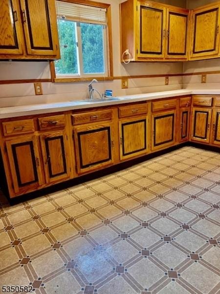 32 High St, Blairstown Twp, NJ 07825 - kitchen featuring brown cabinetry, light countertops, and a sink