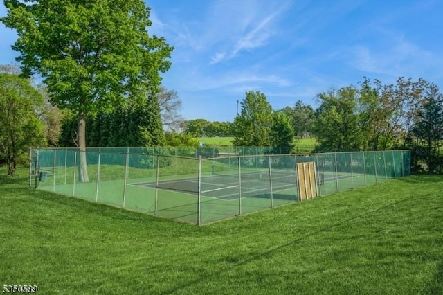 view of tennis court featuring view of scattered trees
