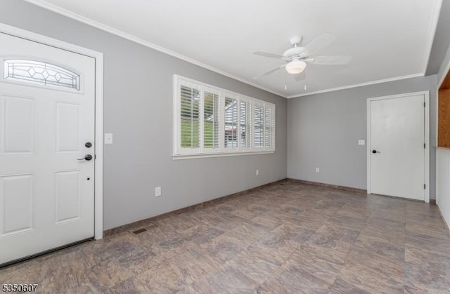 entrance foyer with ceiling fan, ornamental molding, and baseboards