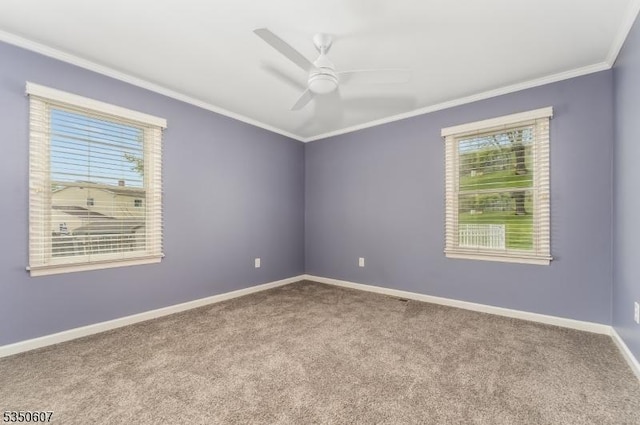 spare room with ornamental molding, carpet, ceiling fan, and a wealth of natural light