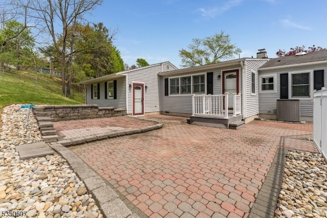 back of property with fence, a patio, and central AC
