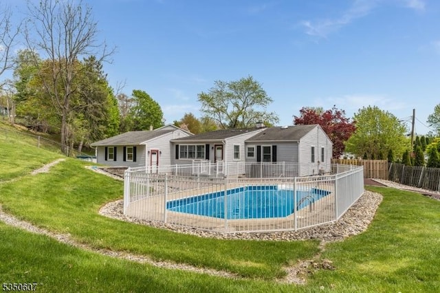view of swimming pool featuring a yard, a fenced in pool, and a fenced backyard