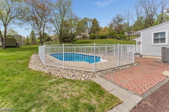 view of swimming pool with fence, central AC, a fenced in pool, a patio area, and a yard