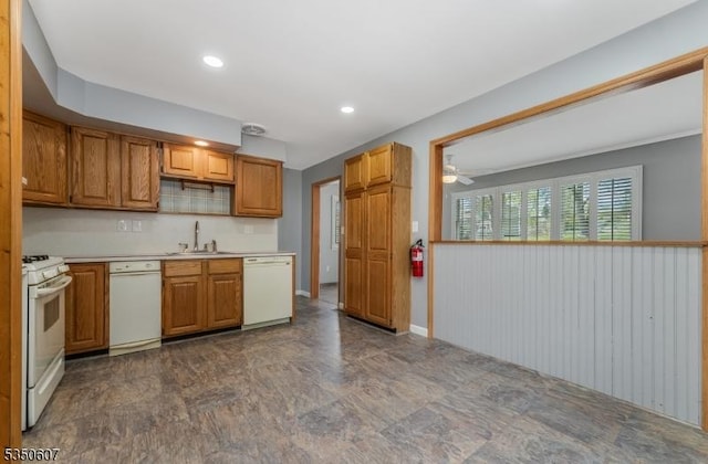 kitchen featuring a sink, brown cabinets, white appliances, and light countertops