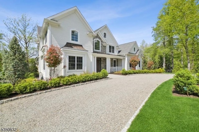 260 Hartshorn Dr, Millburn Twp, NJ 07078 - view of front facade with a standing seam roof, metal roof, and stone siding