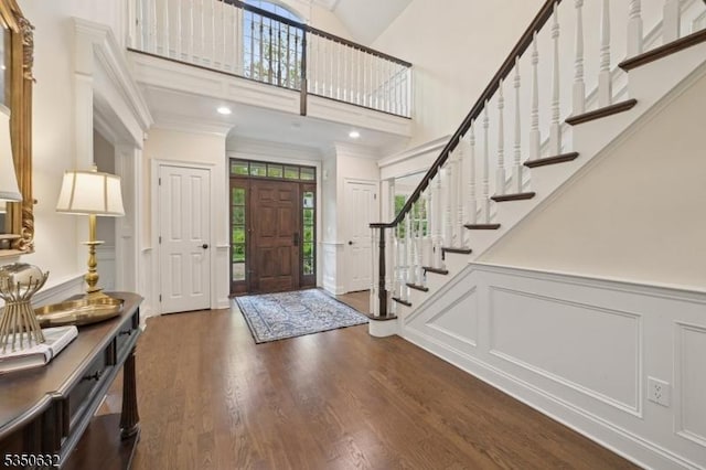 260 Hartshorn Dr, Millburn Twp, NJ 07078 - entryway with a decorative wall, dark wood-style floors, stairway, a towering ceiling, and wainscoting