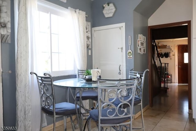 dining space featuring stairway