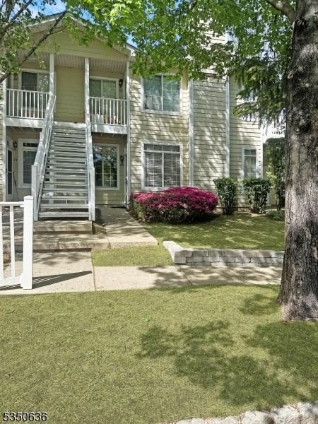 exterior space with a yard and stairs
