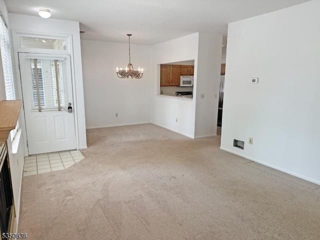 interior space with light colored carpet, baseboards, light tile patterned flooring, and a chandelier