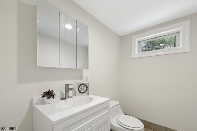 half bathroom featuring toilet and vanity