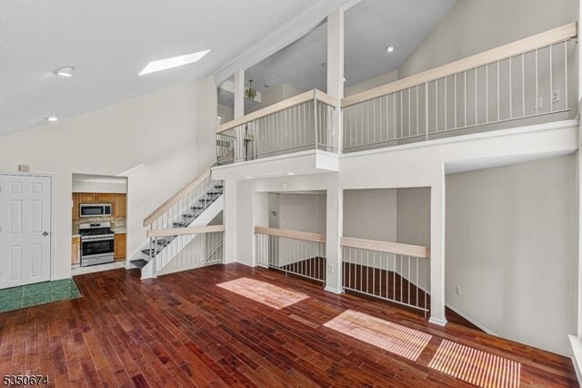 10 Brook St, Franklin Twp, NJ 08873 - unfurnished living room with stairway, high vaulted ceiling, and wood finished floors