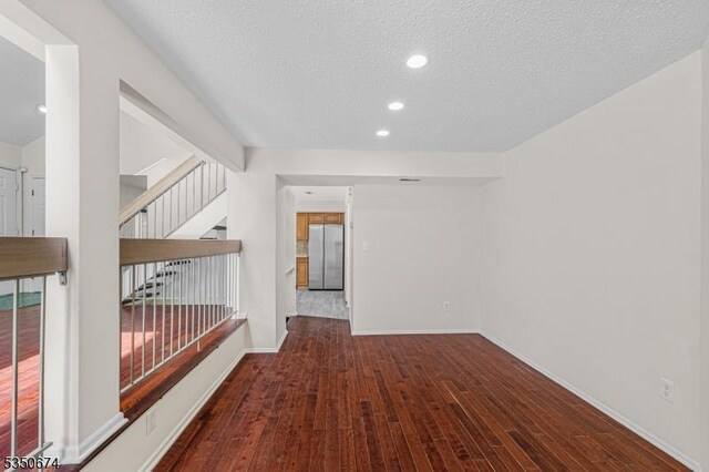 10 Brook St, Franklin Twp, NJ 08873 - hall featuring baseboards, wood finished floors, a textured ceiling, and recessed lighting