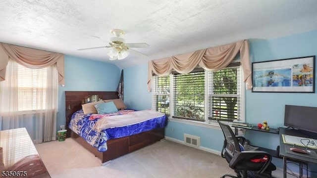 bedroom featuring a ceiling fan, a textured ceiling, visible vents, carpet floors, and baseboards