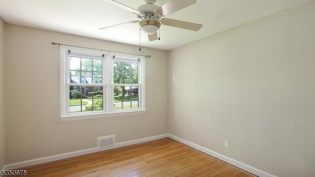 unfurnished room with a ceiling fan, baseboards, visible vents, and light wood-type flooring