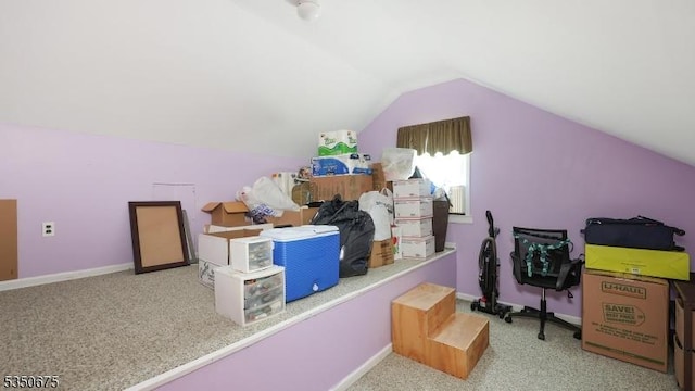additional living space featuring carpet floors, baseboards, and lofted ceiling