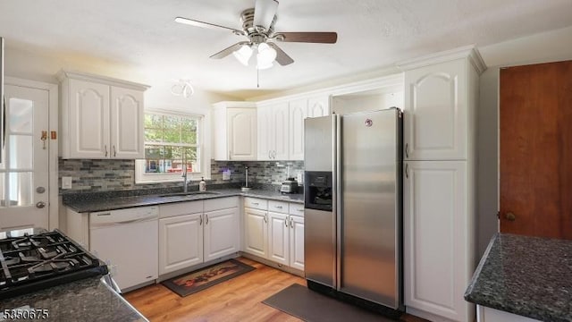 kitchen featuring decorative backsplash, white dishwasher, ceiling fan, stainless steel fridge with ice dispenser, and a sink