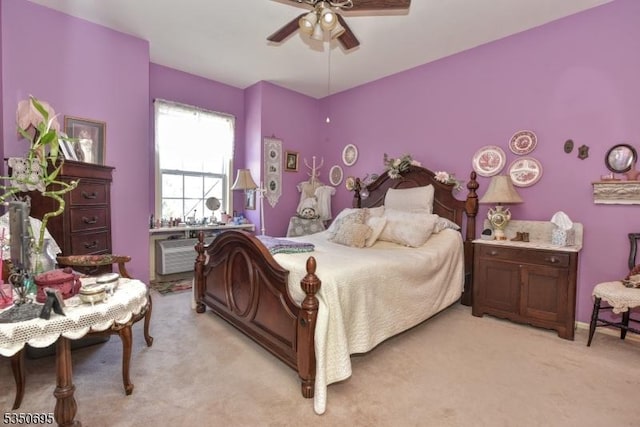 bedroom featuring a ceiling fan and light colored carpet