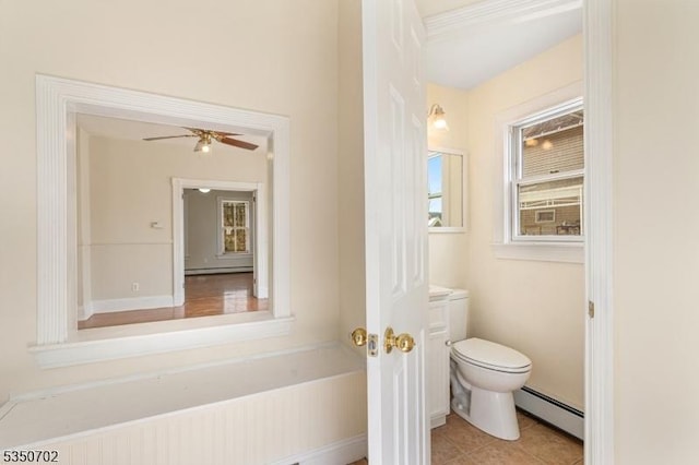 bathroom with toilet, a ceiling fan, tile patterned flooring, and baseboard heating