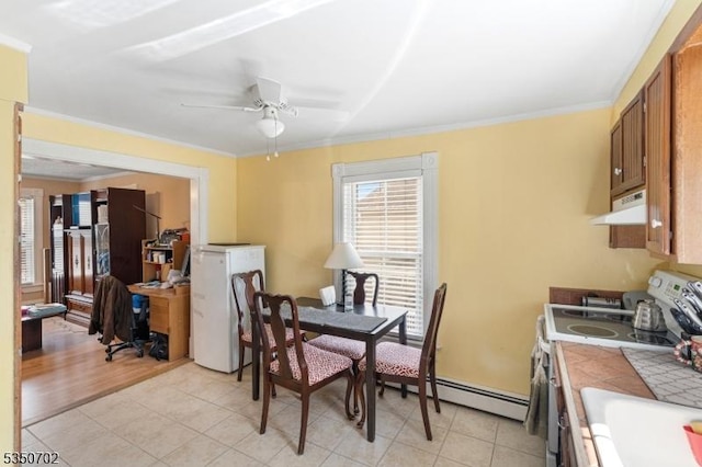 dining area featuring crown molding, light tile patterned floors, and a ceiling fan