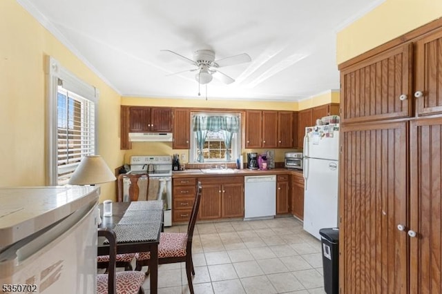 kitchen featuring light tile patterned floors, white appliances, a ceiling fan, ornamental molding, and under cabinet range hood