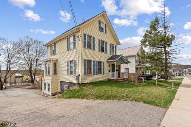 view of side of property with a yard
