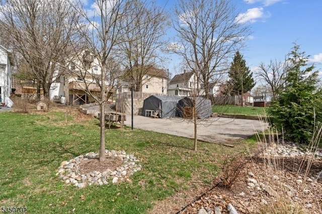 view of yard featuring fence and a residential view