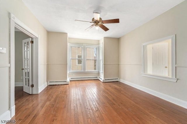 empty room with baseboards, hardwood / wood-style flooring, and a ceiling fan
