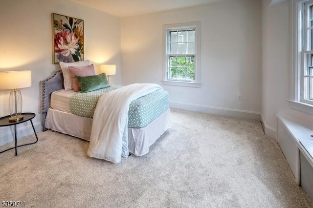 carpeted bedroom featuring baseboards