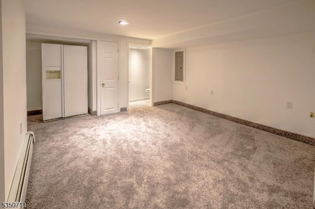 carpeted empty room with a baseboard radiator, baseboards, and electric panel
