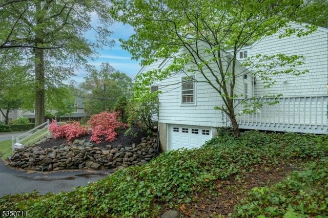 view of property exterior with an attached garage