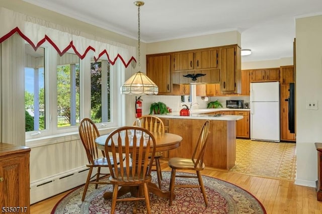 35 Clearview Dr, Randolph Twp, NJ 07869 - kitchen with freestanding refrigerator, brown cabinets, light countertops, and a baseboard heating unit
