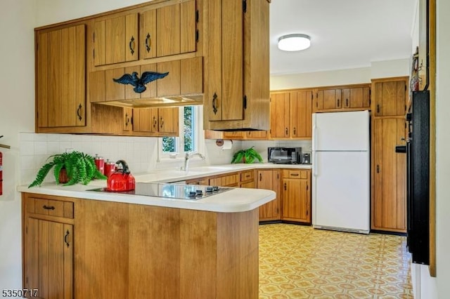 35 Clearview Dr, Randolph Twp, NJ 07869 - kitchen featuring black appliances, brown cabinetry, light countertops, and a peninsula