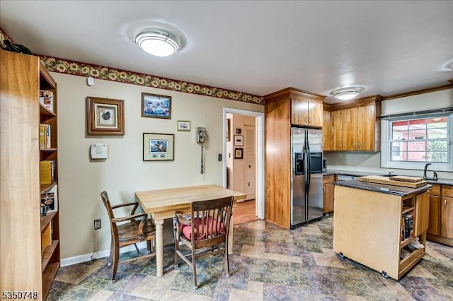 27 Landry Rd, Franklin Twp, NJ 08873 - kitchen featuring open shelves, dark countertops, a sink, brown cabinetry, and stainless steel refrigerator with ice dispenser