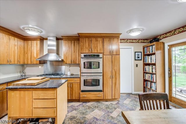 27 Landry Rd, Franklin Twp, NJ 08873 - kitchen with brown cabinetry, wall chimney exhaust hood, dark stone countertops, stainless steel appliances, and a kitchen island